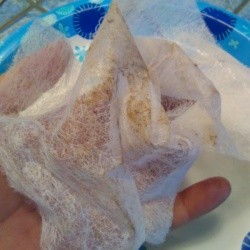 dust covered dryer sheet in woman's hand