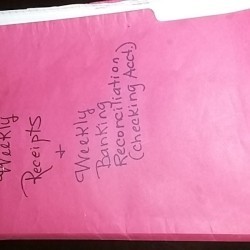 Bank paperwork held in a folder.