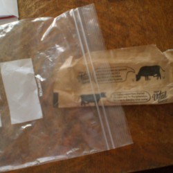 Placing a butter wrapper inside a ziptop bag.