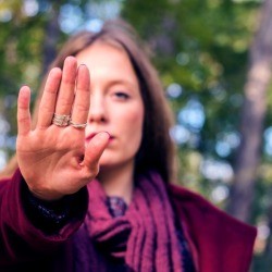 A woman holding up her hand to stop someone.