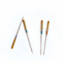 Some sewing machine needles on a white background.