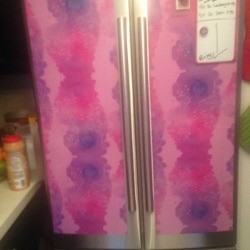 Locker wallpaper on a stainless steel refrigerator.