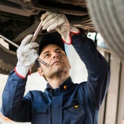 A mechanic working on a car.