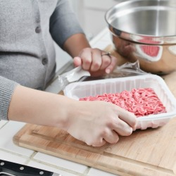 Opening hamburger to prepare poor man's steak.