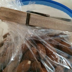 A bag of almonds being closed by a clothespin.