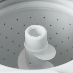A top loading washing machine, empty.