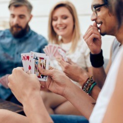 A group of friends playing a card game.