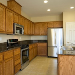 A kitchen with oak cabinets.