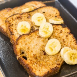 French toast slices in a pan with banana slices.