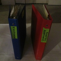 Binders with different warranties stored inside.