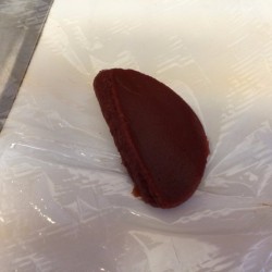 A blob of tomato paste on plastic wrap.