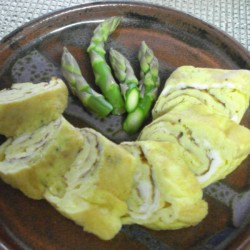 plate with cut tamagoyaki and asparagus