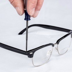 A pair of eyeglasses being repaired.