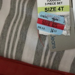 A three piece toddler's outfit with the price marked down.