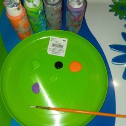 A frisbee being used as a paint palette.