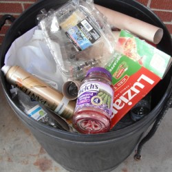 A trash can full of recycling.