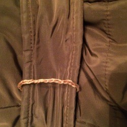 A belt loop on a jacket.