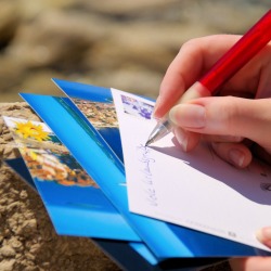 Writing a stack of postcards