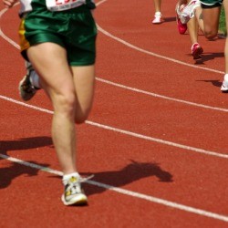 People running at a high school track meet.