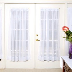 French doors with sheer window curtains.