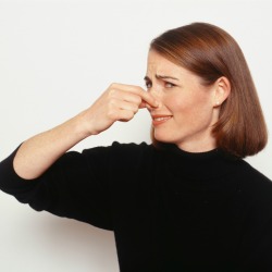 A woman holding her nose.