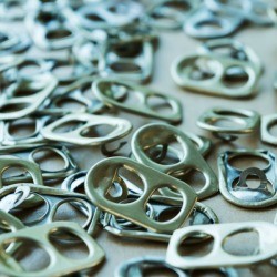 A pile of silver soda can tabs.