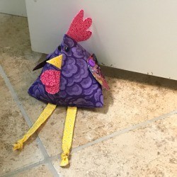 Fabric Chicken Doorstop - being used as a doorstop 
