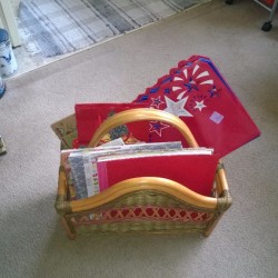 A magazine rack with greeting cards stored inside.