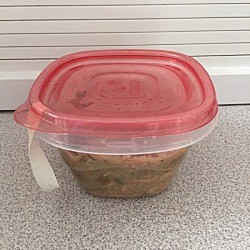 A plastic container with a rubber band sticking out, to help with opening.