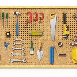 A pegboard with tools hanging on it.