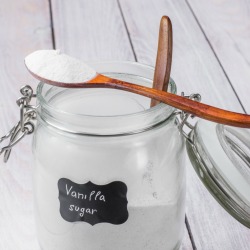 A jar of sugar that has been flavored by vanilla beans.