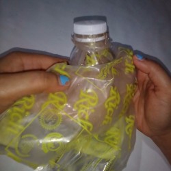 A makeshift closure to a plastic bag, using a bottle top and cap.