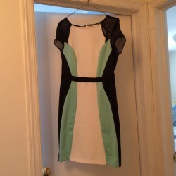 A dress on a hanger in a doorway.