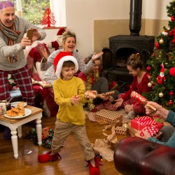 A large family exchanging Christmas gifts.