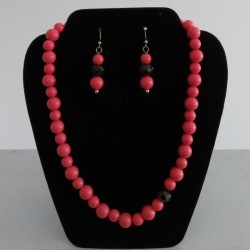 A jewelry display showing a beaded necklace and earrings.