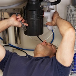 Repairing a garbage disposal.