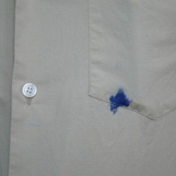 Blue ink stain on a white dress shirt.