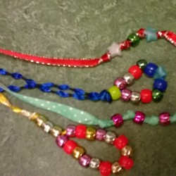 A collection of bead and ribbon bookmarks in different colors.
