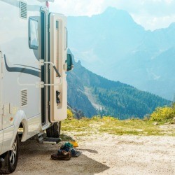 A motorhome parked in the mountains.