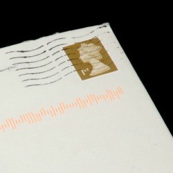 An old post marked envelope with a postage stamp on it.