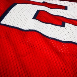 Close-up of a red and white football jersey.