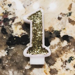 Glitter Candle - closeup of number 1 birthday candle with gold glitter