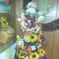 A pencil Christmas tree decorated for fall. 