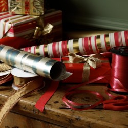 A pile of Christmas wrapping paper and ribbons.