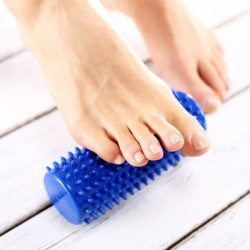 Rolling foot on blue foot massager.