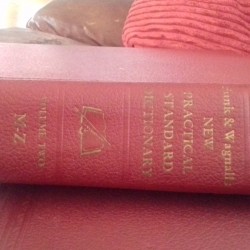 A Funk and Wagnalls dictionary with a red cover.