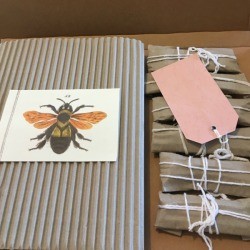 Gifts wrapped in corrugated cardboard with white string.