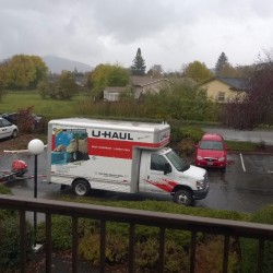 A moving truck parked outside an apartment.