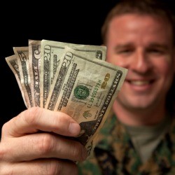 Military Serviceperson Holding Cash