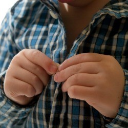 Child Buttoning Shirt